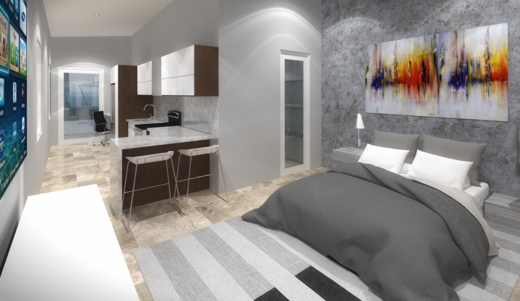 Studio apartment interior with kitchen, bed, and office area